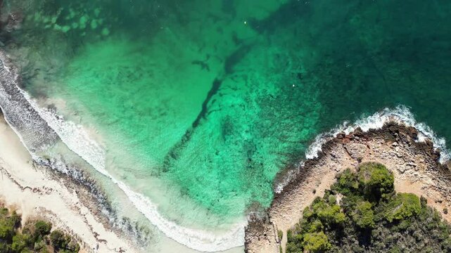 The turquoise beach of Son Saura in Menorca, with rough seas Balearic Islands