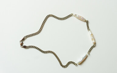 Pearl long collier necklace isolated on white background. Silver necklace chain with natural white...