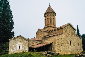 Naklejka premium Ancient Ikalto Monastery in Kakheti, Georgia. Historic medieval stone architecture with a distinctive tower, part of the region’s cultural heritage.
