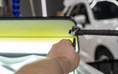 Removing dents on the car. PDR technology. Car body repair without painting. A specialist repairs a dent on the car body without painting. Body car repair.