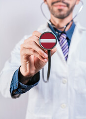 Latvia Health and Medical Insurance Concept. Latvia Healthcare System, Doctor Holding Stethoscope