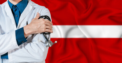 Doctor With Stethoscope On Latvia Flag. Doctor Holding Stethoscope On Latvia Flag