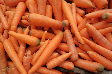 Fresh, vibrant orange carrots (wortel) displayed at a traditional food stall (warung), showcasing their natural color and crisp texture