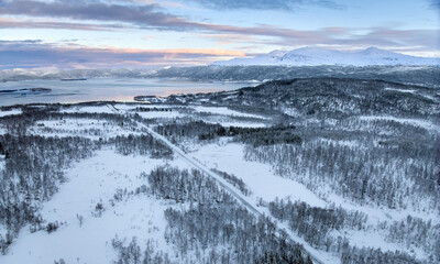 country road in the snowy highland landscape of Senja Island in northern Norway