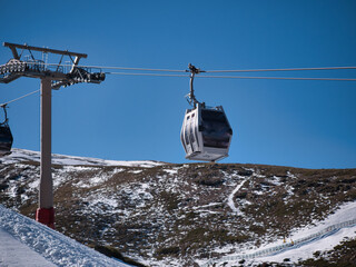 Gondola lifts that go to the top of the ski resort so that skiers and snowboarders can start the...