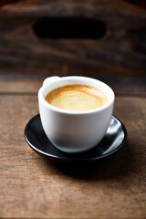 Cup of coffee on wooden background. Soft focus. Copy space