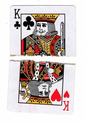 A vintage picture playing card made up of torn halves on a white background.