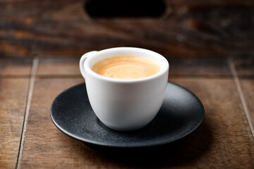 Cup of coffee on wooden background. Soft focus. Copy space