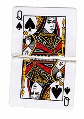 A vintage playing card made up of torn halves.