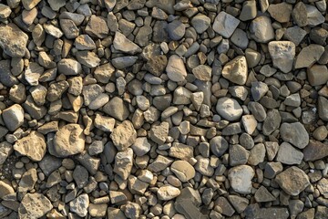 Assorted crushed stones and gravel in shades of grey and brown. Textured natural rock background for construction, landscaping, and geology concepts.