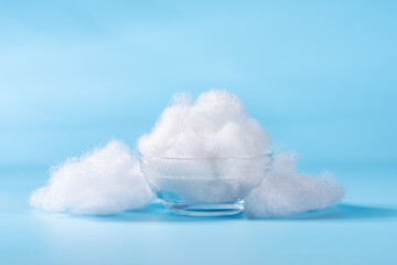 closeup of polyester stable fiber on blue background. synthetic fibre