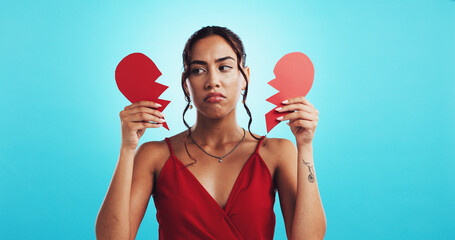 Heartbreak, depressed and woman with paper heart, studio and girl with failed relationship and mockup space. Blue background, thinking and breakup on valentines day, ripped and sad person on date