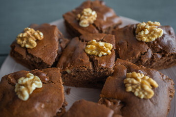 Oatmeal cake with bananas and walnuts on a dark grey background in home kitchen