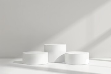 three white cylindrical podiums on a white background. Minimalist design for product display or presentation
