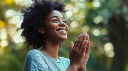 A person clapping their hands outdoors, smiling and radiating positivity.