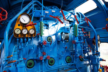Control panel of an old steam locomotive inside with gauges and pressure gauges, close-up