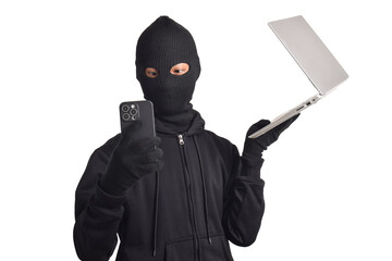 Mysterious man wearing black hoodie and mask doing computer and smartphone hacking activities,...