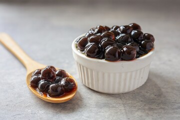 Black pearls for bubble mllk tea in a white bowl on grey background