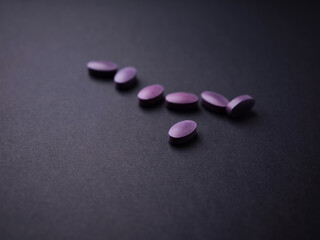 Lutein tablets. Dietary supplement on paper background. Soft focus. Close up. Copy space	