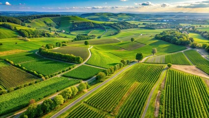 Fototapeta premium Rolling hills of emerald green vineyards stretch as far as the eye can see in a breathtaking aerial view of the Loire Valley, countryside, countryside views