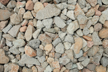 Naklejka premium A close-up view of crushed stone (batu split) showcasing its rough texture and irregular pattern, commonly used in construction