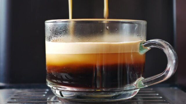 Professional espresso machine while preparing  espressos coffeeglass in a coffee shop. Close-up of espresso pouring from the coffee machine	