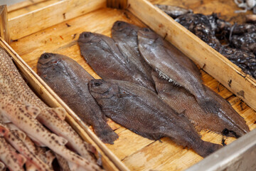 Fresh Flatfish Arranged in a Wooden Crate at Fish Market