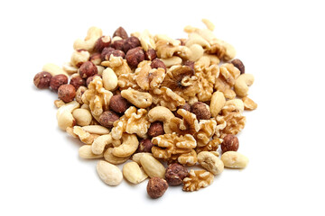 Mixed nuts including walnuts, cashews, almonds, and hazelnuts in a pile on a white background. Perfect for healthy snacking, baking, or trail mixes