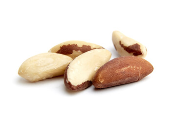 Obraz premium Close-up of several Brazil nuts, displaying smooth creamy surfaces and rich brown textures, arranged naturally on a white background