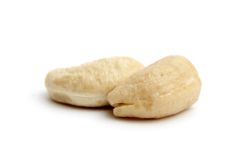 Two raw cashew nuts with a smooth texture, placed on a white background. Ideal for healthy eating, snack, vegan food, or plant-based diet themes