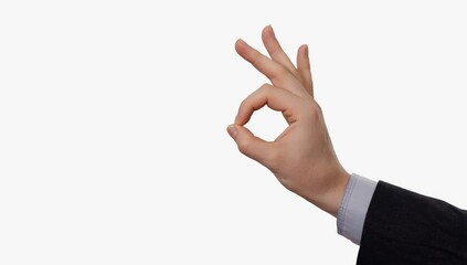 Naklejka premium Businessman hand gesturing ok sign, signaling agreement and positivity against clean white backdrop