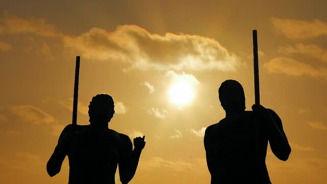 Sunset Timelapse:  Guanche- backlit statues as the clouds pass behind them