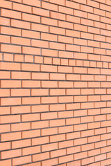 Brick wall side view background. Orange brick wall background for exterior design. Construction concept, outdoor buildings, garage or house. Wall with classic checkerboard pattern and visible joints