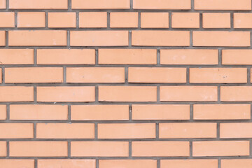 Orange brick wall background for exterior design. Construction concept, outdoor buildings, garage or house. Wall with classic checkerboard pattern and visible joints