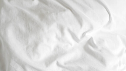 White clean hotel bedsheet with soft texture and smooth fabric folds.
