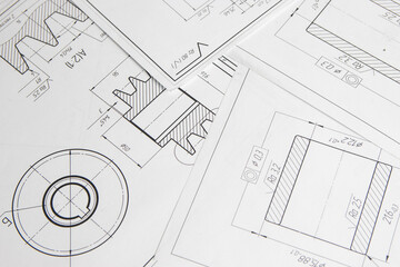 paper engineering drawings of industrial parts and mechanisms	