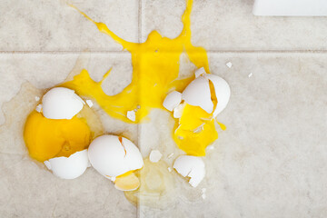 Dropped eggs making a mess on kitchen floor
