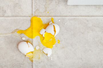 Dropped eggs making a mess on kitchen floor