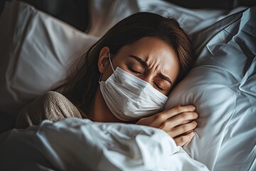 Sick woman wearing mask resting in bed