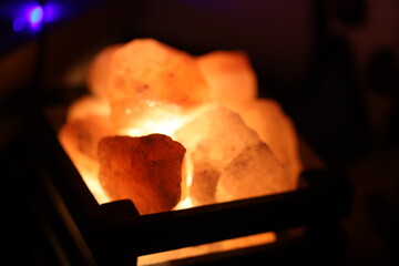 A close-up shot of a Himalayan salt lamp on a table, great for decorative and wellness uses.