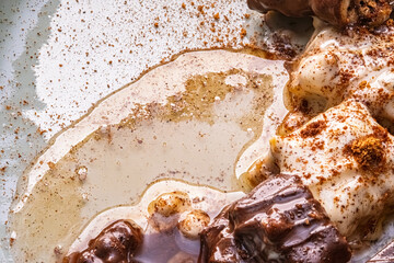 Chocolate and honey. Melted chocolate and syrup. The visual appeal of the drizzled sauces invites viewers to explore the sweetness within.