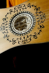 Close up view of a baroque guitar isolated on black background
