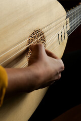 Hands of a woman playing the baroque guitar