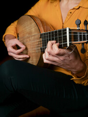 Woman playing a lute instrument