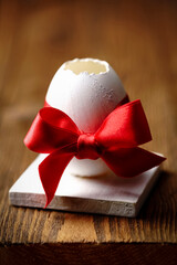 Easter egg with red ribbon, close-up, card