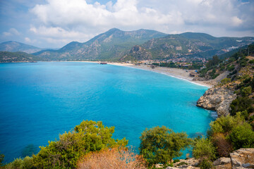 Obraz premium Aerial view of Oludeniz beach with people and boats in the morning, Coastline next to Fethiye, Turkey