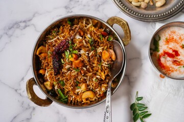 Tamarind rice or Puliyogare | Puliyodharai served with yogurt, selective focus