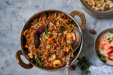 Tamarind rice or Puliyogare | Puliyodharai served with yogurt, selective focus