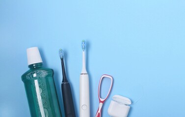 Daily dental care essentials including toothbrushes, mouthwash, and floss on blue background
