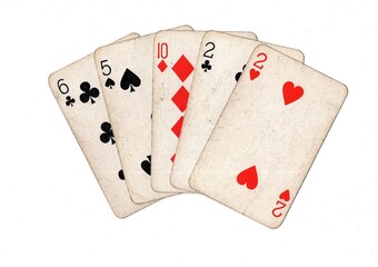 A poker hand of vintage playing cards on a white background.